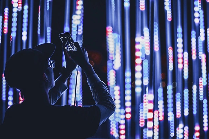 A man in front of streams of light