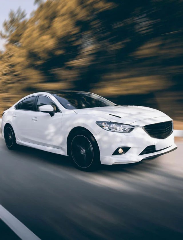  A white car speeding down the road