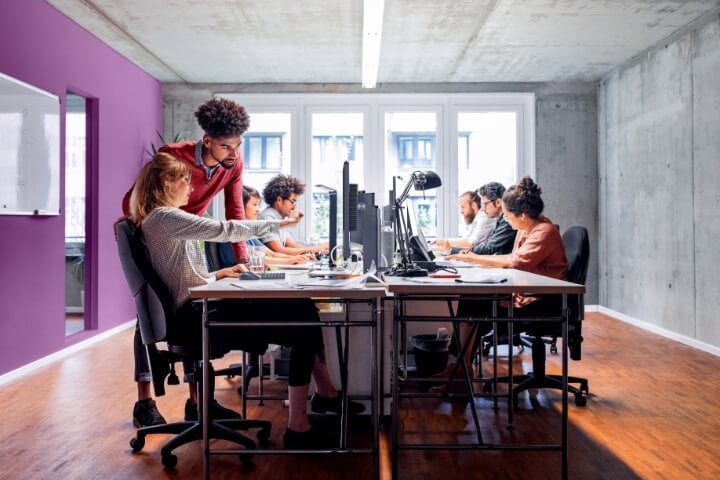 TruScale Workers Sitting by their computers