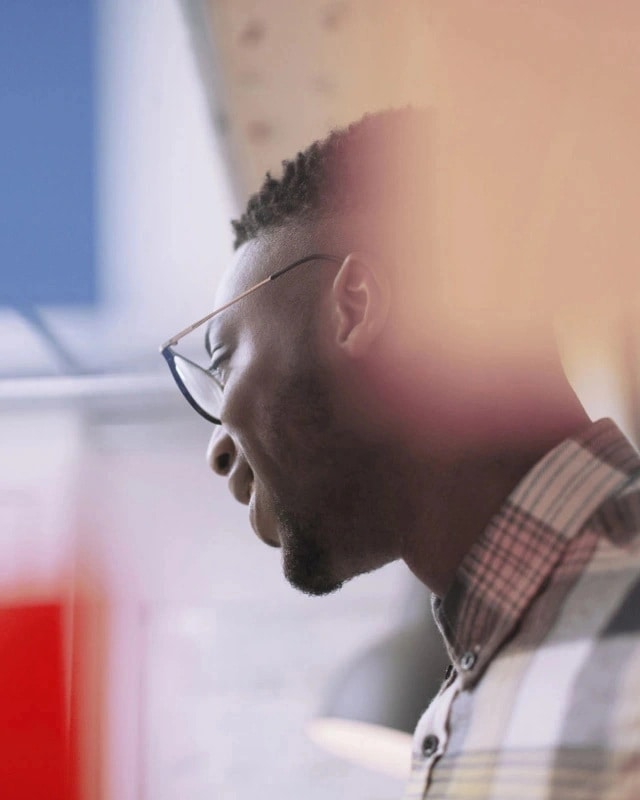 Man looking away in a campus library