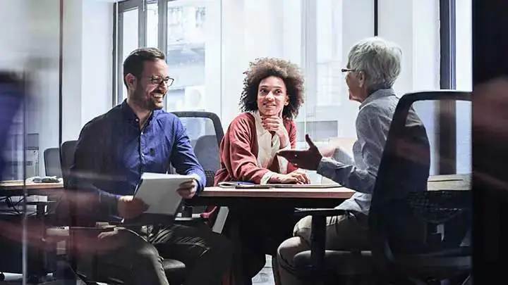 Three colleagues having a meeting at the office