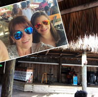 Mother and daughter enjoy live music performed in a beach cafe