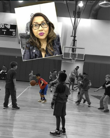 Mother takes selfie with a son who is playing basketball