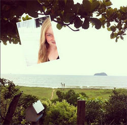 Selfie of a blonde girl relaxing near at a riverbank