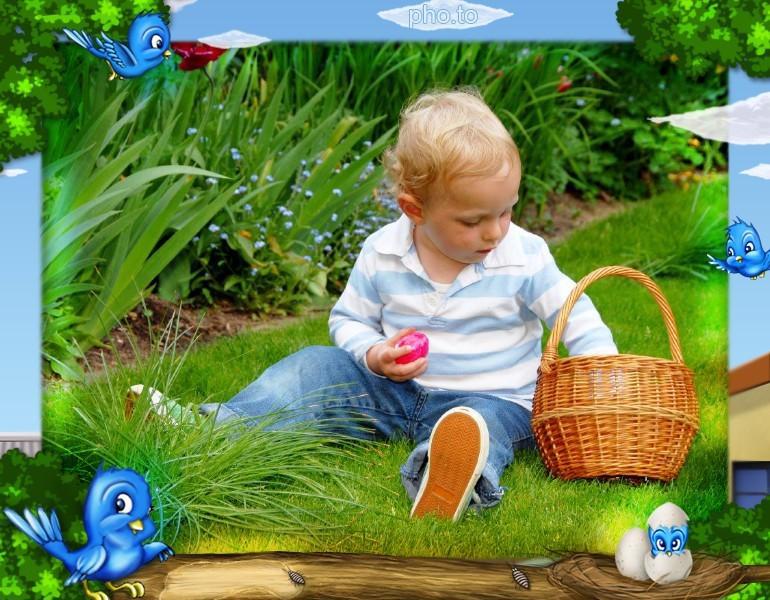 A boy holding a painted egg in the garden