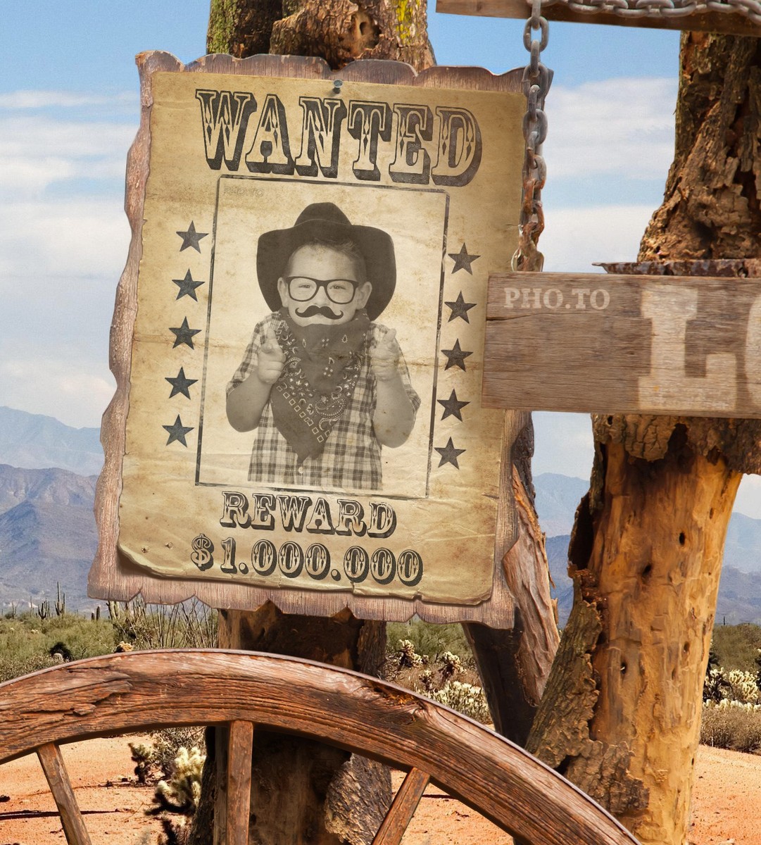 A photo of a small boy was placed into the Wanted poster photo frame