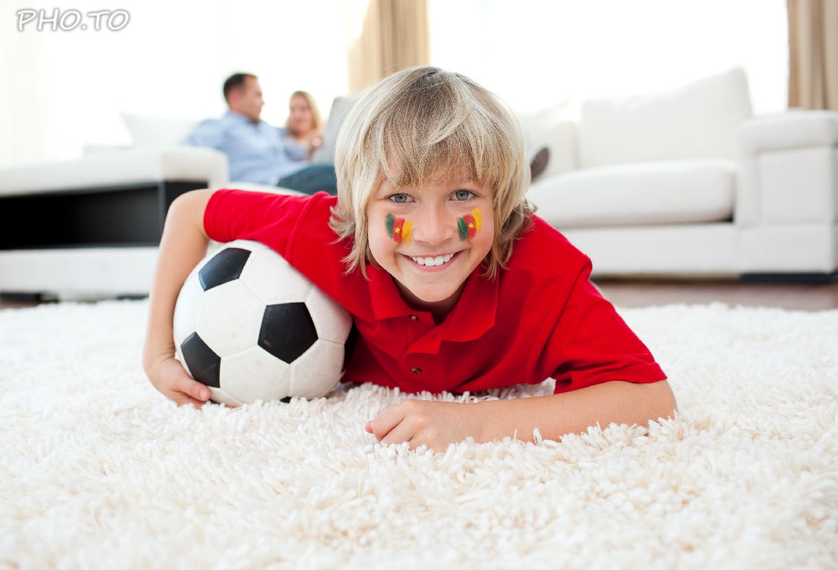 A virtual Flag of Cameroon was added to a portrait photo of young football fan