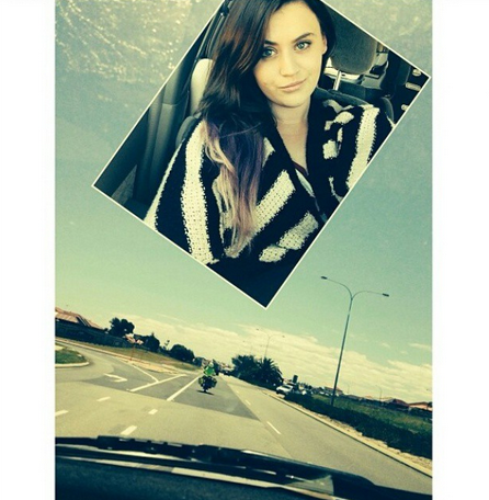 Young beautiful girl sits in a car