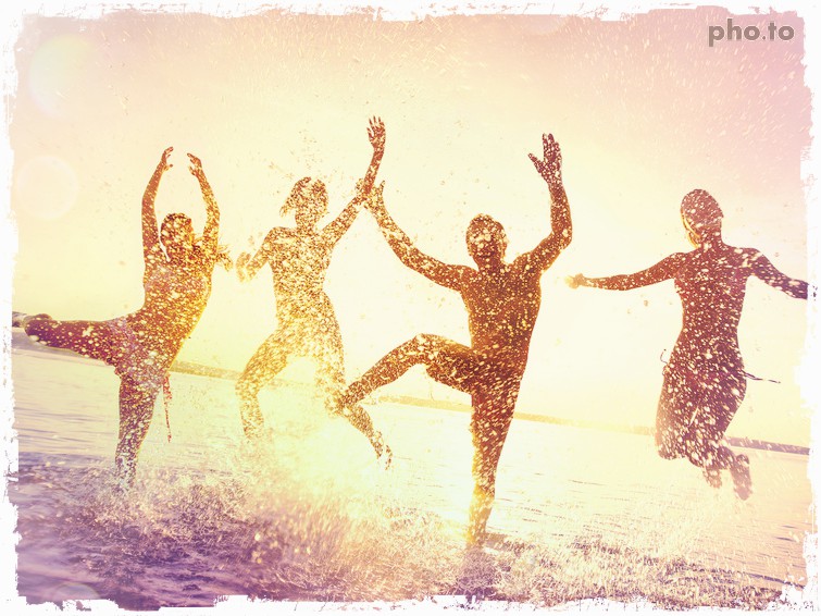 A photo of 4 people dancing in water on a beach, edited with a color filter