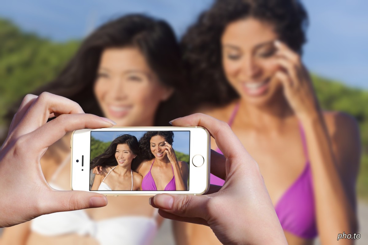 A photo of two girls being photographed