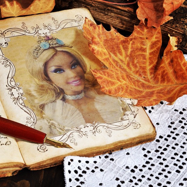 Autumn photo frame with a photo of a Barby doll