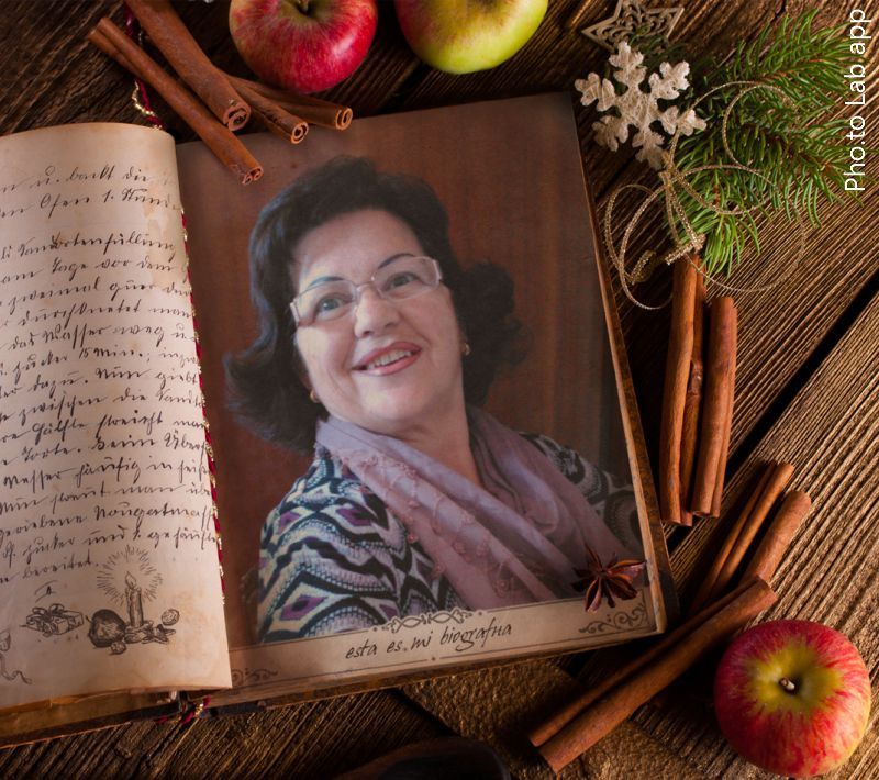 Unusual Christmas frame with cinnamon, apples and fir tree twig is added to a photo of an aged attractive woman