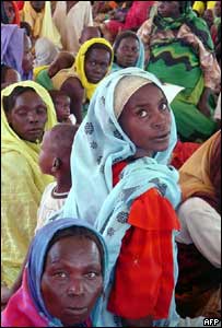 Women and children wait at a camp in Darfur