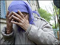 A woman cries as she is evacuated