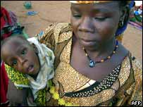 A woman with her child at a feeding station in Niger