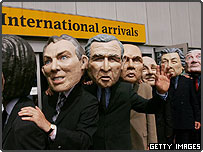 Protestors wearing masks of G8 leaders