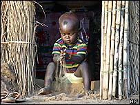 A boy plays with sand on the outskirts of Abuja, Nigeria