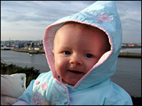 A smiling baby overlooking Aberdeen harbour