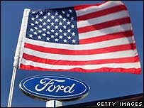 Ford logo under a fluttering US flag