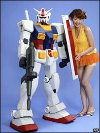 A model poses next to a plastic model of one of the robots in series Gundam (file image)