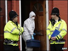 Police officers at raided property