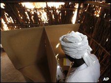 Man voting in Darfur refugee camp