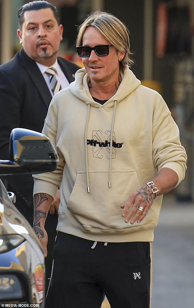 The New Zealand-born singer, 56, exuded confidence and style as he made his way through the bustling terminal in a $1,500 Off-White beige hoodie paired with black exercise pants