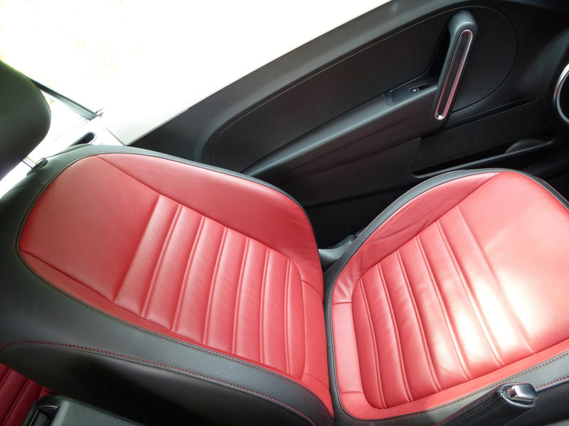 Colorful red leather seat with black trim in a modern car in a high angle view