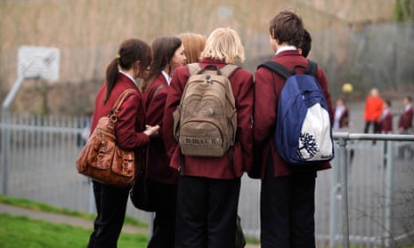 A group of secondary school children in school uniform