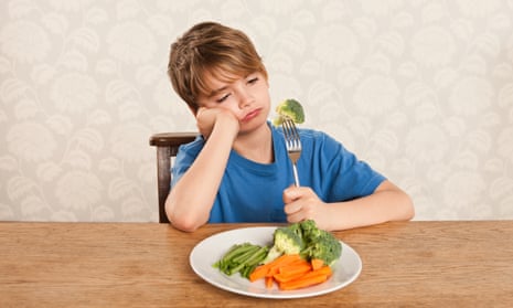 Boy frowning at vegetables