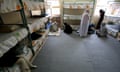 Two veiled women in a prison cell