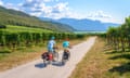 Two cyclists with mountain bike, on the Via Claudia Augusta cycle path, crossing the Alps