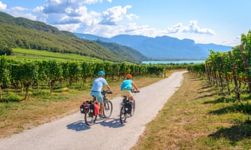 Two cyclists with mountain bike, on the Via Claudia Augusta cycle path, crossing the Alps