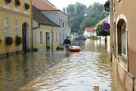 A man wades through a flooded street