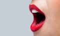 Close up of a womans mouth wide open with bright red lipstick on her lips.