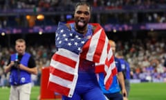 Noah Lyles celebrates after winning the men's 100m final.