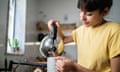 Young woman preparing a tea at home