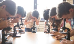 Students using microscopes in a science class