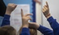 Children’s raised hands in a classroom