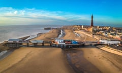 An aerial shot of Blackppol's golden beach  with its North and Central piers and the Tower