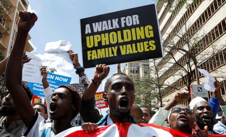 Angry-looking young black men shouting and waving placards, the most prominent saying a ‘walk for upholding family values’ 