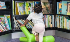 Child looking at books in a school library