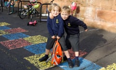 Two children outside a school