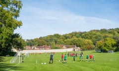 Schoolchildren playing football on private school playing fields