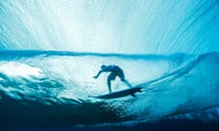 Australia's Jack Robinson rides in a barrel in the 2nd heat, during round one of the surfing competition, during the 2024 Summer Olympics, in Teahupo'o, French Polynesia, Saturday, July 27, 2024. (Ben Thouard/Pool Photo via AP)