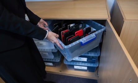 school principal Vicki Dean with an example of a phone box in a lockable cabinet