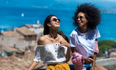 Two persons in a seaside village enjoying the sunshine