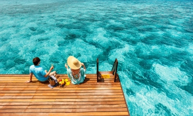 a couple relaxing by the sea with a picnic