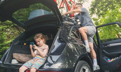 father and daughter packing things in their car for a trip