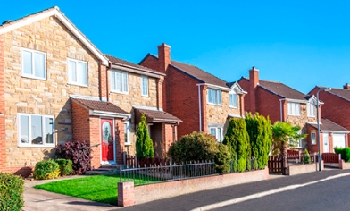 Row of houses on left side of a long road